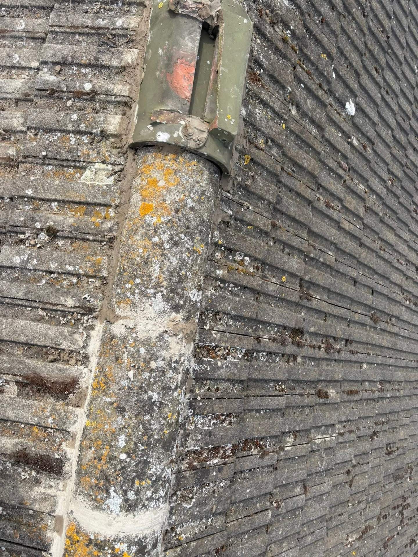 Replacement ridge tile bedded in and pointed along a clean ridge line