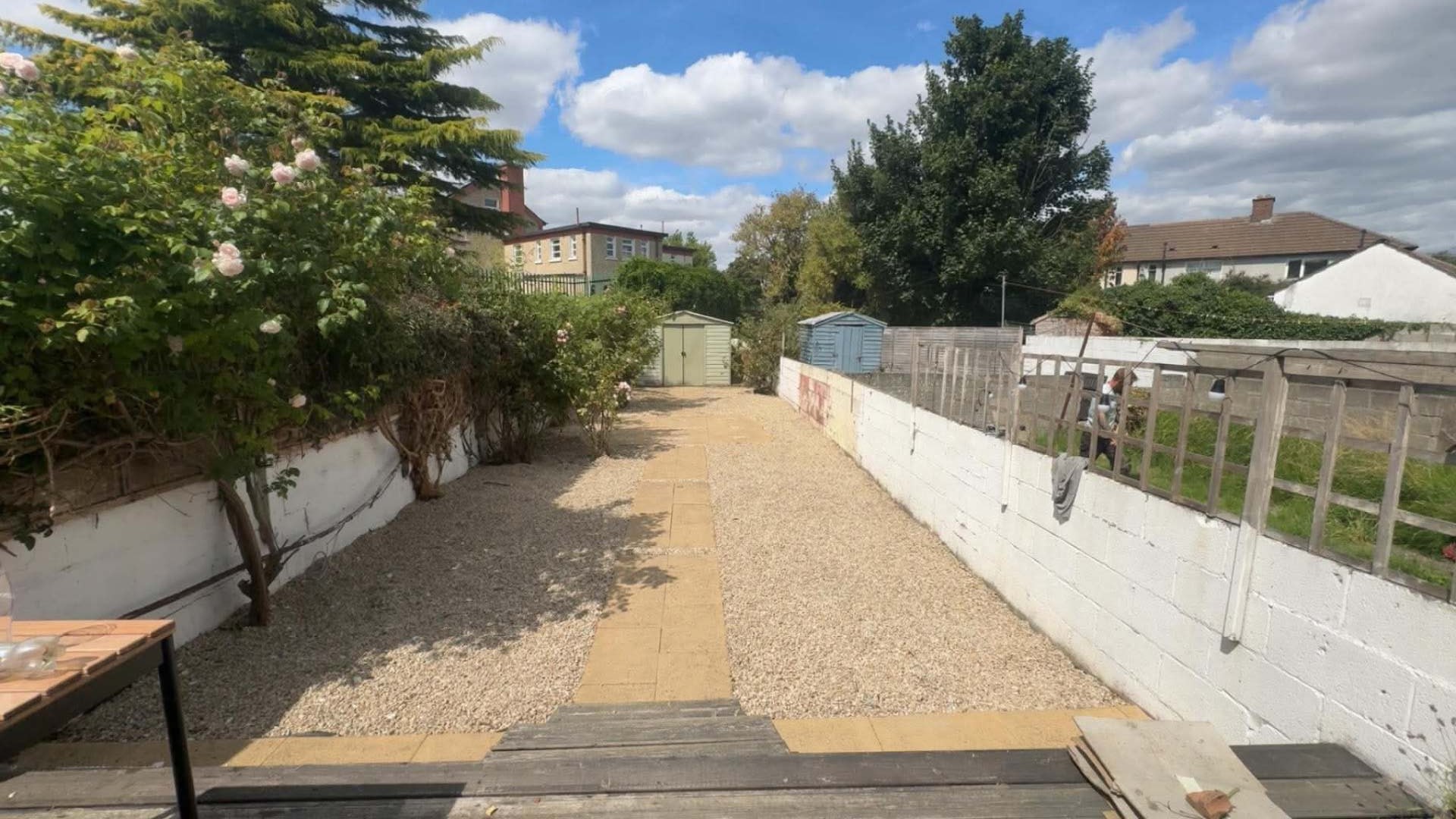Same back garden cleared out with clean paving and fresh gravel laid down both sides
