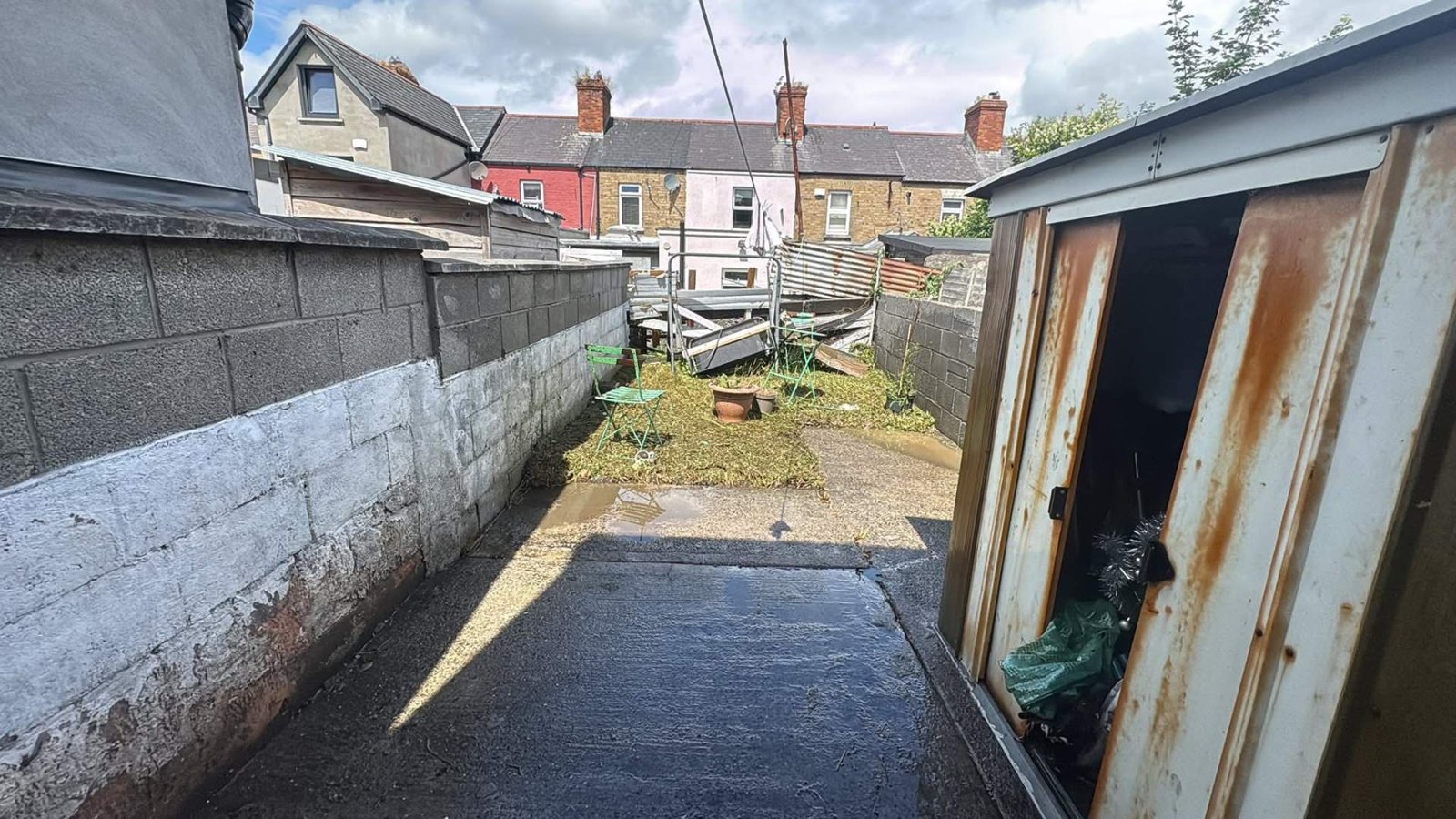 Back yard concrete and paving cleaned down after power washing